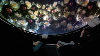 Two people sitting in a Setl immersive projection dome