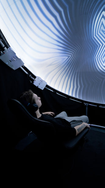 Man sitting in Setl immersive projection dome