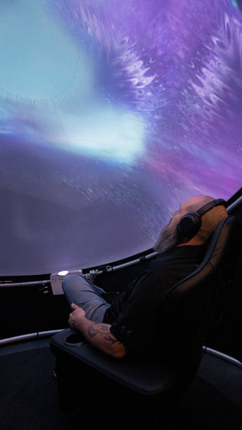 Man seated in Setl immersive projection dome