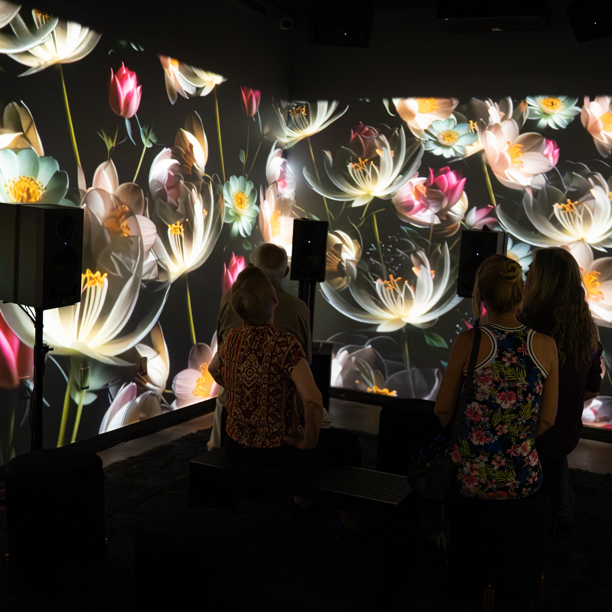 People standing in a Setl immersive multi-wall projection room